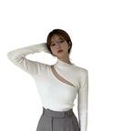 Close-up of hollow knit detail on Black off shoulder sweater
